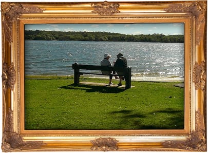 Photo: Couple sitting by beach